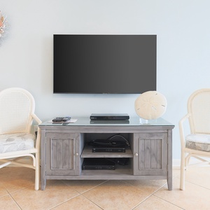 Unwind in the living space, featuring a large TV and charming decor, perfect for relaxation after a day of fun