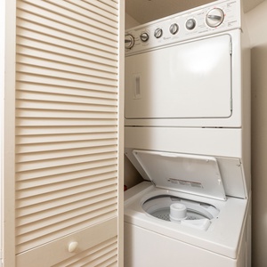 Washer and dryer tucked neatly behind louvered doors, providing convenience for laundry during your beach getaway
