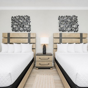 Make yourself comfortable and relax by the lamp's warm glow between two queen beds