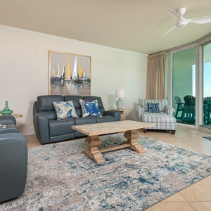 This living area features comfortable seating, a stylish coffee table, and a bright view through expansive glass doors