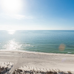 Bask in the sun while enjoying serene views of the gentle waves and expansive shoreline from your balcony