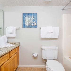 Refresh in the guest bathroom featuring a spacious vanity, decorative accents, and a relaxing shower area