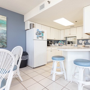 Gather around the breakfast bar with friends, enjoying the cheerful decor and easy access to the kitchen