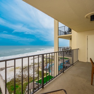 Enjoy breathtaking views from the spacious balcony overlooking the serene beach and tranquil waves