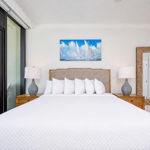 Experience restful nights in the master bedroom featuring a large king bed, soft linens, and elegant decor