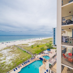 Relax on the balcony while taking in views of the beach and the inviting pool area below