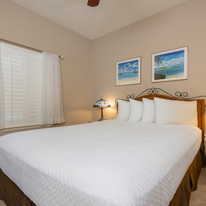 Rest comfortably in this inviting guest bedroom, featuring a plush queen bed, soft lighting, and charming decor