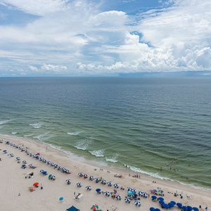 Breathe in the fresh air on your spacious balcony, soaking in the serene views of the coast and beach activities below