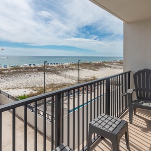 This balcony offers a stunning beach view with comfortable seating for relaxation and enjoyment