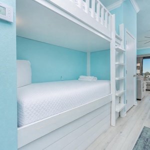 This cozy bunk area with twins lets you unwind in quiet comfort after beach fun