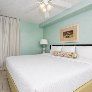 Relax in the serene bedroom suite featuring a king bed, soft linens, and a flat-screen TV for your entertainment