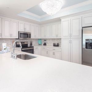 Prepare meals in this kitchen with elegant cabinetry, stainless appliances, and spacious countertops
