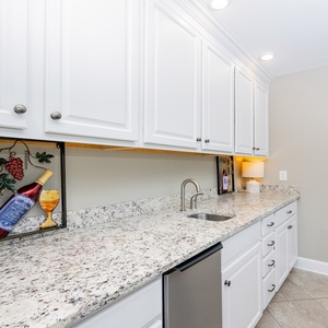 Craft refreshing drinks at the stylish wet bar, enhancing your coastal retreat experience