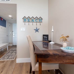 Welcoming entryway features a rustic bench, decorative sign, stylish desk with a lamp, complimentary Wifi, and floral accent