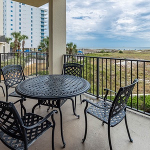 Balcony seating invites relaxation with views of the beach and lush greenery, perfect for enjoying morning coffee