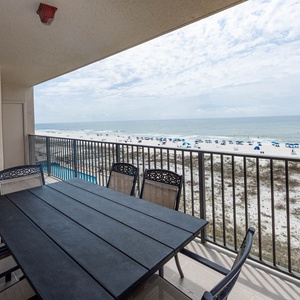 Dine at the outdoor table while enjoying refreshing coastal breezes and views of the beach below