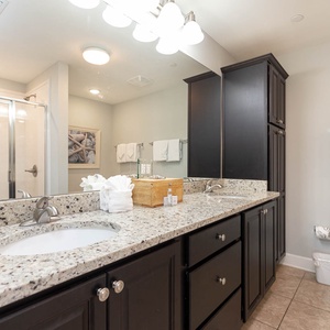 Experience the master bathroom with dual sinks, stylish cabinetry, jetted tub, and a walk-in shower