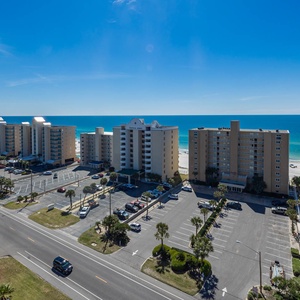 This bright view showcases a serene beach scene with vibrant blue waters and nearby palm trees, perfect for relaxation