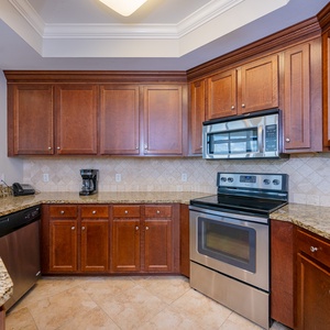 Whip up family favorites with ease in this welcoming kitchen, surrounded by rich wood cabinetry and stainless appliances
