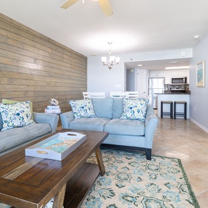 Cozy living area featuring a soft blue sofa with a queen sleeper, cozy loveseat with vibrant pillows, and relaxing vibe
