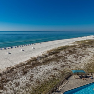 Bask in the sun by the inviting gradual entry pool, with easy access to the beach and comfortable lounge chairs nearby