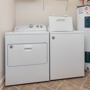 Conveniently manage your laundry with a washer and dryer in this practical utility space, designed for your ease