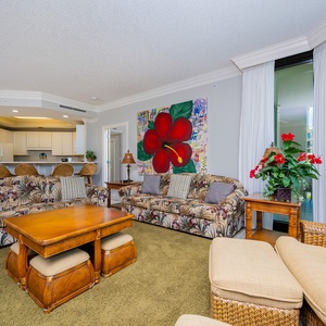 Sink into plush seating surrounded by vibrant artwork and fresh blooms, embracing relaxation in your coastal getaway