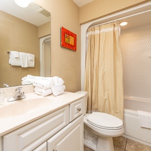 Refresh in this guest bath, enjoying the soft towels and vibrant decor that energizes your daily routine