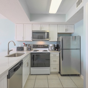 This kitchen features sleek modern appliances, granite countertops, and a bright, airy atmosphere perfect for meal prep