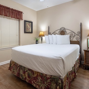 Charming geust bedroom featuring a queen bed, tasteful decor, and warm lighting for a peaceful night's sleep