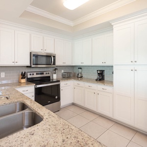 Craft delicious meals while enjoying the sleek countertops and inviting layout of this fabulous kitchen