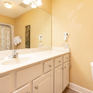Indulge in a refreshing start in this guest bath, preparing for a day of beachside fun in style and comfort