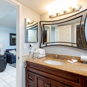 Refreshing master bath featuring a stylish granite countertop and a spacious mirror, perfect for your morning routine