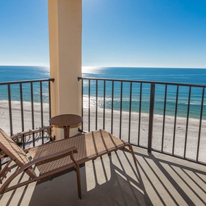 Relax on the balcony with a magnificent view of the shimmering coastline and serene beach below