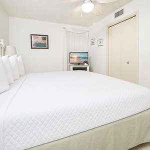 Plush king bed, a flat-screen TV, and tasteful artwork, creating a serene retreat atmosphere