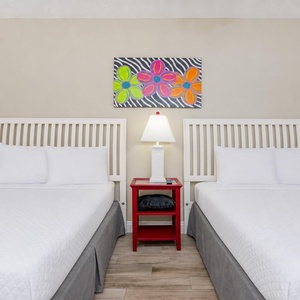 Find comfort on plush queen beds, surrounded by cheerful decor that invites relaxation and restful nights