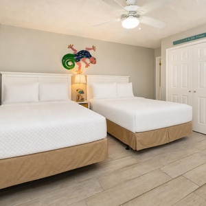 Rest soundly in this charming guest room with two cozy double beds, accented by playful decor