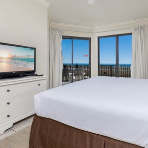 Inviting master suite with a comfortable king bed and beachfront ground floor patio access