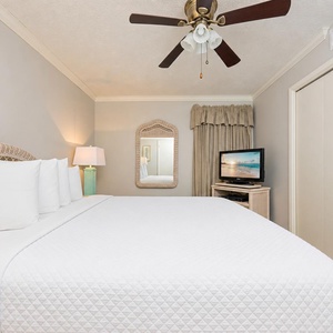 Cozy up in the king suite as you enjoy your favorite shows on the TV, surrounded by beach decor