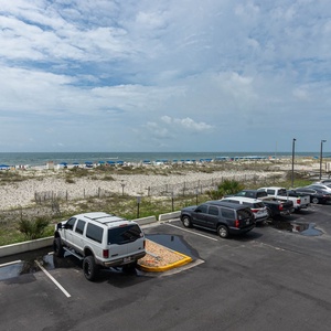 Enjoy a relaxing view of the beach from this inviting balcony, perfect for unwinding after a day of fun