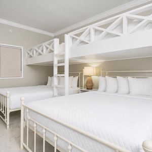 Sleep comfortably in this bunk room featuring two queen beds and a cozy loft area with two twins, perfect for families