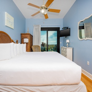 Bright blue walls complement the cozy king bed in the master, with balcony access on the beach