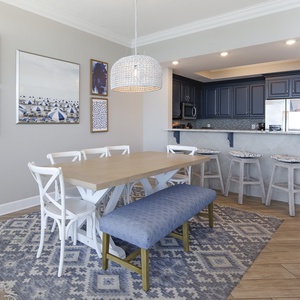 Savor moments around the dining table, as laughter fills the air and coastal artwork sparks joy in this inviting space