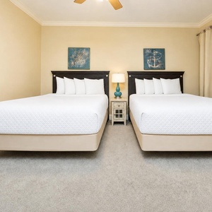 Two queen guest suite beds offer plush rest after long days of beachside adventures together
