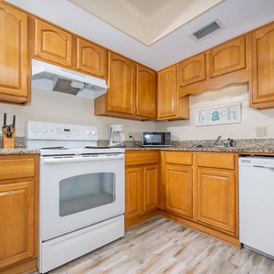 Inviting kitchen featuring warm wood cabinets, granite countertops, and modern appliances