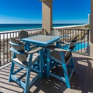 Enjoy meals or drinks at the patio table with chairs, overlooking the expansive shore and tranquil water