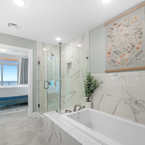 Indulge in relaxation in the master bath with a refreshing and elegant glass shower and soothing tub