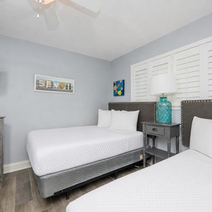 Two cozy double beds invite relaxation in this guest suite after a fun day on the beach