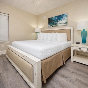 Rest comfortably in the inviting bedroom featuring a plush king bed, stylish decor, and a flat-screen TV for entertainment