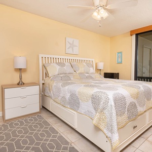 Bright and inviting master bedroom featuring a king bed, stylish decor, and a lovely view from the balcony